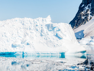 Iceberg with calving ice and snow floating in Errera Channel, Antarctic Peninsula, Antarctica © TasfotoNL
