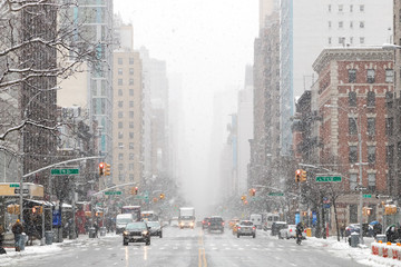 Snowy winter street scene looking down 3rd Avenue in the East Village of Manhattan during a...