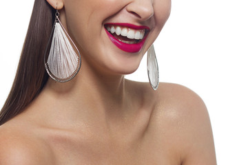 Fototapeta premium Beautiful smile with whitening teeth. Dental photo. Macro closeup of perfect female lipscare. Perfect pink lip makeup. Perfect clean skin, light fresh lip make-up. Isolated. Good sunny mood