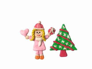 Pretty girl holding the pink heart and red gift box and cute Christmas tree made from plasticine clay placed on white background, cute child dough wearing a coat in winter festival