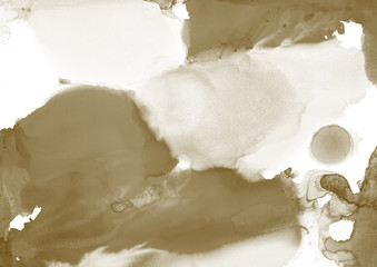 Gold alcohol ink wash texture on clean paper background. Liquid paint flow. Transparent ethereal effect.