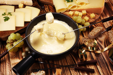 Gourmet Swiss fondue dinner on a winter evening with assorted cheese
