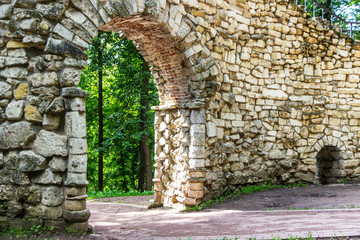 Old stone entrance wall in the garden of ancient castle
