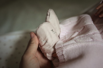 sleeping newborn girl in a knitted dress and cap