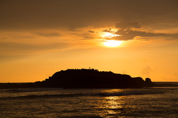 Naklejka premium Sunset over a small island off the beaches of Punta Mita, Mexico