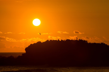 Sunset over a small island off the beaches of Punta Mita, Mexico