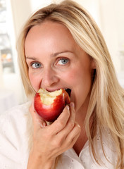 WOMAN EATING A RED APPLE