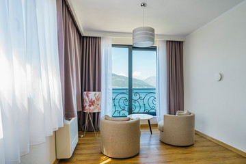 Fototapeta na wymiar Interior of a spacious light bedroom with sea view in a luxury villa