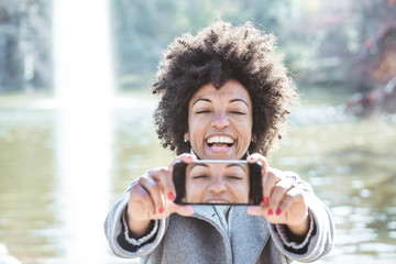 Portrait of attractive afro woman taking selfie portrait