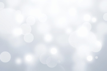 Grey silver glowing blurred bokeh abstract background.