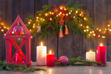 wooden lantern with candles and Christmas branchs on wooden background