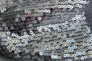 Grey metalic beads on fabric. Christmas background