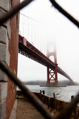The Golden Gate Bridge Through a Chain Link Fence