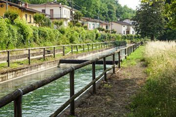 An irrigation canal wends its way through italy farmland .