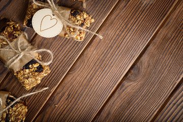 Homemade granola oatmeal energy bars, on wood desk wyth copy space for text