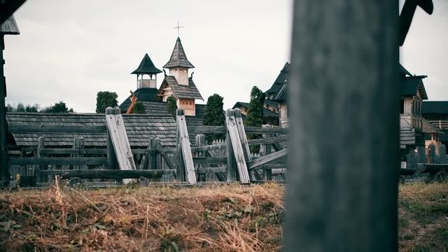 An ancient Slavic pagan city built of wood, excellent scenery for a historical film, old wooden churches and houses, an orthodox cross, summer time, no people in the frame, old Kiev