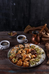 Turkish Dessert Baklava with coffee on silver tray, copy space
