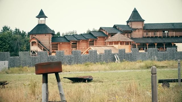 An ancient Slavic pagan city built of wood, excellent scenery for a historical film, old wooden churches and houses, an orthodox cross, summer time, no people in the frame, old Kiev
