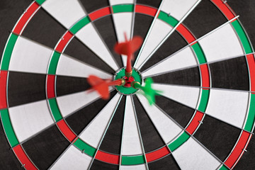 Three Darts hit red target on the target right close-up