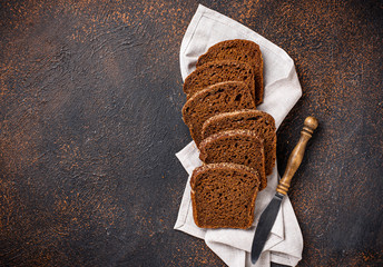 Fresh sliced rye bread on rusty background
