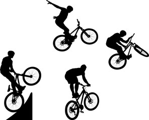 silhouette of male doing bike trick