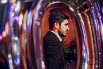 The entertainer. Young elegant talking man holding microphone
