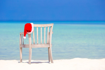 Red santa hat on beach chair at tropical vacation