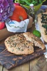 Bread with seeds. Homemade pastries are healthy and tasty. Healthy food and photo in rustic style. Wooden background and food. View from above.