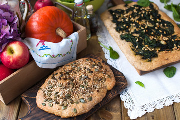 Bread with seeds. Homemade pastries are healthy and tasty. Healthy food and photo in rustic style. Wooden background and food. View from above.