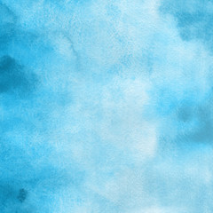 Blue watercolor winter texture with abstract washes and brush strokes on the white paper background.