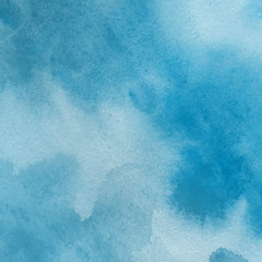 Blue watercolor winter texture with abstract washes and brush strokes on the white paper background.