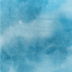 Blue watercolor winter texture with abstract washes and brush strokes on the white paper background.