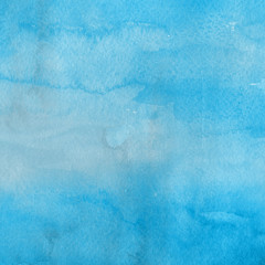 Blue watercolor winter texture with abstract washes and brush strokes on the white paper background.