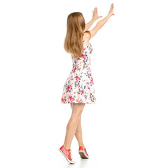 Beautiful woman in dress with flowers print and sneakers showing of positive emotions showing taking  back view on white background isolation