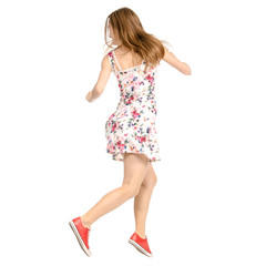 Beautiful woman in dress with flowers print and sneakers showing of positive emotions runs back view on white background isolation