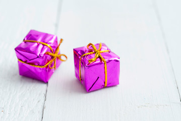 Purple gift box on white wood