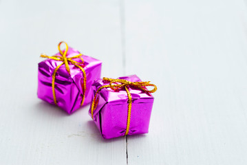 Purple gift box on white wood