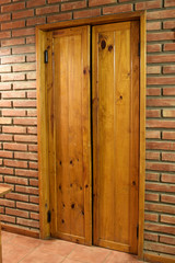 wooden door in a red brick wall