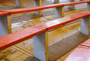 Rows of empty wooden stadium seats . close up