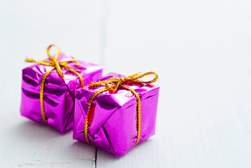Purple gift box on white wood
