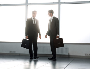 Fototapeta premium background image. two businessmen standing in the lobby of the office