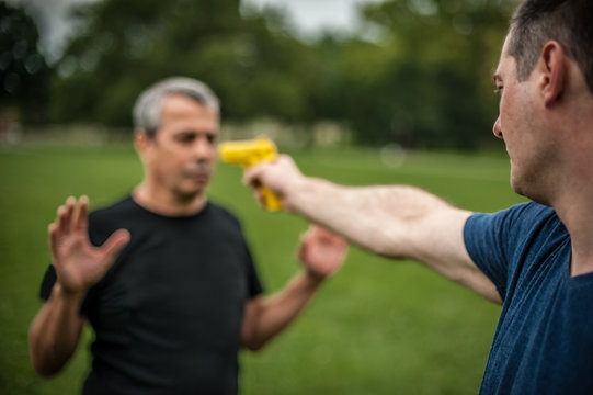 Gun point. Kapap instructor demonstrates self defense techniques against threat