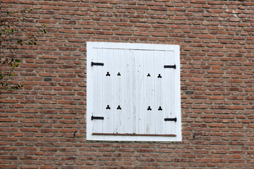 wooden antique window in a red brick wall