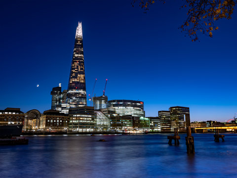 London Skyline at Night from across the River Thames with the Shard, the tallest building in the UK and Europe.