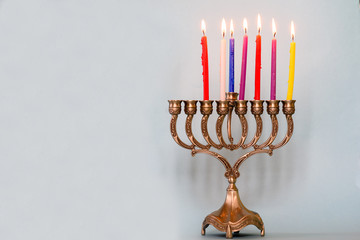 Sixth day of Hanukkah with burning Hanukkah colorful candles in Menorah (traditional Candelabra) .Chanukkah-jewish holiday. Each night, another candle is added. Copy space for text.