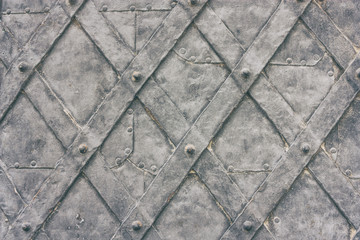 Old metal wrought door of medieval building close up, horizontal grunge background