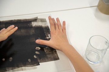 Taking fingerprints with a black paint hand