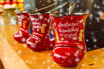 Traditional german holiday drink - punch (Feuerzangenbowle) in cup in the form of shoe with German...