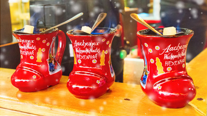 Traditional german holiday drink - punch (Feuerzangenbowle) in cup in the form of shoe with German...