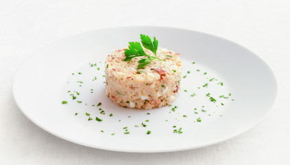 mayonnaise salad with mackerel, egg, onion and rice decorated with parsley